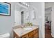 Bathroom features granite counters, neutral walls, tiled floors, vanity and framed mirror at 2108 Canterbury Rd, Clayton, NC 27520