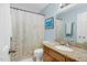 Bathroom features granite counters, neutral walls, tiled floors, and a floral shower curtain at 2108 Canterbury Rd, Clayton, NC 27520