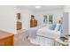Bright bedroom with neutral walls, carpeted floors, and a window at 2108 Canterbury Rd, Clayton, NC 27520
