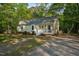 Well-kept home boasts a classic front porch, complemented by the natural beauty of its wooded surroundings at 2108 Canterbury Rd, Clayton, NC 27520