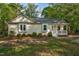 Inviting single-story house features a cozy front porch and well-maintained landscaping at 2108 Canterbury Rd, Clayton, NC 27520