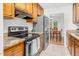 Spacious kitchen features tiled floors, granite counters, stainless appliances, and wood cabinets at 2108 Canterbury Rd, Clayton, NC 27520