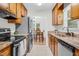 Spacious kitchen features tiled floors, granite counters, stainless appliances, and wood cabinets at 2108 Canterbury Rd, Clayton, NC 27520