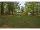 Picturesque property featuring a home, outbuilding, and lush greenery at 2108 Canterbury Rd, Clayton, NC 27520