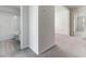 View into a bathroom with a modern shower-tub combo and neutral color palette from the hallway at 2137 Caen St, Raleigh, NC 27610