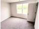 This is a cozy bedroom with soft carpeting and a bright window at 2137 Caen St, Raleigh, NC 27610