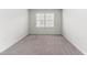 A carpeted bedroom with a window at 2137 Caen St, Raleigh, NC 27610
