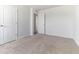 Bright bedroom showcases a neutral palette, soft carpeting, and access to an adjoining room through an open doorway at 2137 Caen St, Raleigh, NC 27610