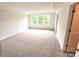 Bright bedroom with soft carpet, a large window, and recessed lighting at 2137 Caen St, Raleigh, NC 27610