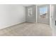 A cozy bedroom with neutral walls, plush carpeting, and two windows offering pleasant neighborhood views at 2137 Caen St, Raleigh, NC 27610