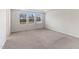 A bright bedroom features neutral walls, plush carpet, and three large windows offering pleasant views at 2137 Caen St, Raleigh, NC 27610