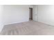 Bright bedroom with neutral walls and plush carpeting and open doorway to the next room at 2137 Caen St, Raleigh, NC 27610
