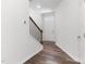 Bright entryway featuring hardwood floors, a staircase with dark iron railings, and a white front door at 2137 Caen St, Raleigh, NC 27610