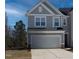 Charming two-story home with a two-car garage and a well-maintained lawn at 2137 Caen St, Raleigh, NC 27610