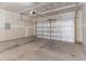 An empty two car garage featuring a white garage door and concrete flooring at 2137 Caen St, Raleigh, NC 27610