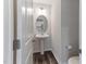 Cozy half bathroom featuring a pedestal sink, oval mirror, and neutral wall paint at 2137 Caen St, Raleigh, NC 27610