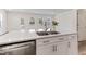 A kitchen island with a sink, dishwasher, and white cabinets at 2137 Caen St, Raleigh, NC 27610