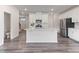 Open concept kitchen featuring a large island, white cabinets, and stainless steel appliances at 2137 Caen St, Raleigh, NC 27610