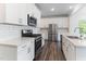 A kitchen with white cabinets, stainless steel appliances, and subway tile backsplash at 2137 Caen St, Raleigh, NC 27610