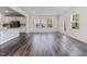 Open concept living room with hardwood floors, stainless steel appliances, and natural light at 2137 Caen St, Raleigh, NC 27610