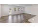 Spacious living room with hardwood floors, white walls, and an exit door with multiple windows at 2137 Caen St, Raleigh, NC 27610