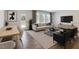 Living room with modern furniture, wood floors, large windows, and natural light at 2137 Caen St, Raleigh, NC 27610