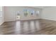 Spacious living room featuring gray wood floors, white walls, and plenty of natural light at 2137 Caen St, Raleigh, NC 27610