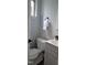 A gray bathroom features a toilet, vanity, and window, showcasing its compact design and providing essential amenities at 220 Elizabeth St # A-17, Chapel Hill, NC 27514