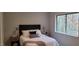 Well-lit bedroom features a large window with wooded views, neutral walls, and tasteful decor at 220 Elizabeth St # A-17, Chapel Hill, NC 27514