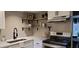 Updated kitchen featuring light gray subway tile backsplash, open wood shelving, and stainless steel appliances at 220 Elizabeth St # A-17, Chapel Hill, NC 27514