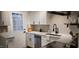 Bright kitchen features white cabinets, stainless steel appliances, and a door to the exterior at 220 Elizabeth St # A-17, Chapel Hill, NC 27514