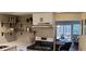 Open kitchen with wood shelving and stainless steel appliances overlooks the living area at 220 Elizabeth St # A-17, Chapel Hill, NC 27514