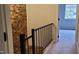 A landing features a brick wall, a railing, and a window, providing an aesthetic transition between floors at 220 Elizabeth St # A-17, Chapel Hill, NC 27514