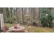 Outdoor patio with table and chairs, surrounded by lush greenery and trees at 220 Elizabeth St # A-17, Chapel Hill, NC 27514