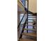 The modern floating staircase features wood treads and views into a living area, blending design with natural light at 220 Elizabeth St # A-17, Chapel Hill, NC 27514