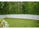White fence in backyard with lush lawn and greenery at 228 Adefield Ln, Holly Springs, NC 27540