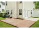 A brick patio next to a door and air conditioner surrounded by a manicured lawn at 228 Adefield Ln, Holly Springs, NC 27540