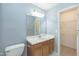 Bright bathroom with vanity, large mirror, and ample storage at 228 Adefield Ln, Holly Springs, NC 27540