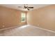 A naturally lit room with neutral tones, complemented by a ceiling fan and carpet at 228 Adefield Ln, Holly Springs, NC 27540