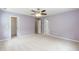 Spacious bedroom with ceiling fan, plush carpet, and ample closet space at 228 Adefield Ln, Holly Springs, NC 27540