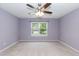 Large bedroom with ceiling fan and large window with a view at 228 Adefield Ln, Holly Springs, NC 27540