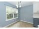 Bright dining area featuring a large window and modern light fixture with view to kitchen at 228 Adefield Ln, Holly Springs, NC 27540