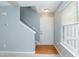Bright entryway featuring hardwood floors, stairs leading up, and a large window at 228 Adefield Ln, Holly Springs, NC 27540