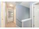 Well-lit hallway with neutral paint, plush carpet, and white trim at 228 Adefield Ln, Holly Springs, NC 27540