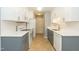 Modern kitchen with white cabinets, stainless steel appliances, and hardwood floors at 228 Adefield Ln, Holly Springs, NC 27540
