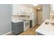 Bright kitchen features stainless steel appliances, white cabinets, and updated countertops at 228 Adefield Ln, Holly Springs, NC 27540