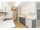 Updated kitchen featuring modern appliances, gray cabinets, and tile backsplash at 228 Adefield Ln, Holly Springs, NC 27540