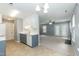 Modern kitchen with gray and white cabinets and stainless steel appliances, open to the living room at 228 Adefield Ln, Holly Springs, NC 27540