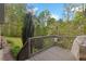 Wooden back deck with a railing and view of lush greenery, offering a relaxing outdoor space at 2456 Nealwood Ave, Graham, NC 27253