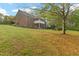 Expansive, well-manicured lawn with mature trees surrounding the brick home at 2456 Nealwood Ave, Graham, NC 27253